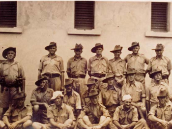 Soldiers sitting and standing in a group