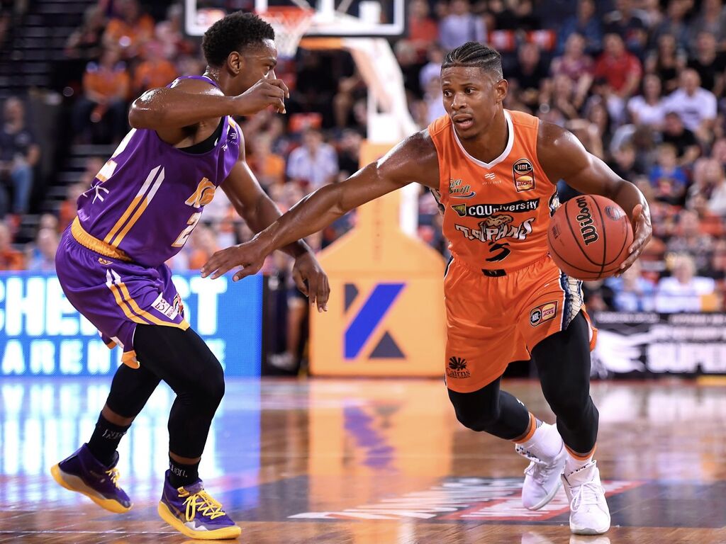 A Taipans player and opposition both going for tip-off 