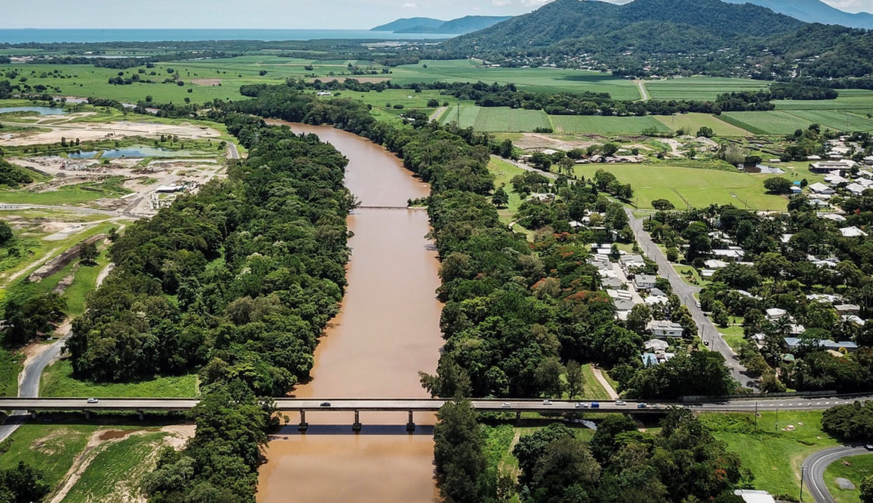 Aerial shot of a bridge over Barron River with traffic 