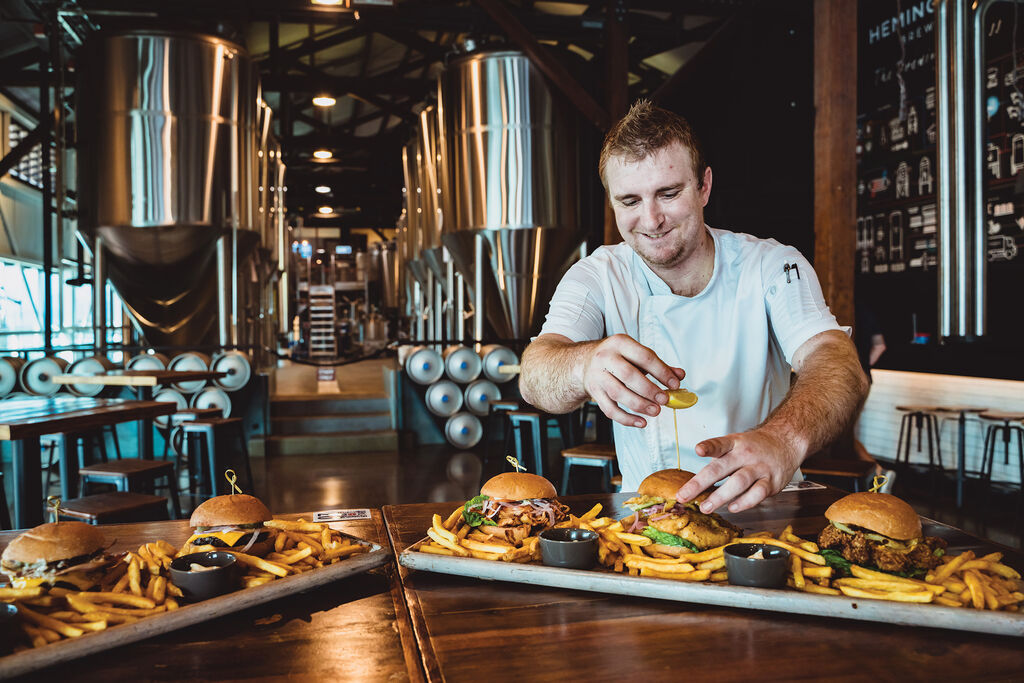 Hemingway's Head Chef Reid Brydon putting a spike in a burger bun