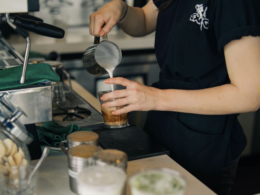 Generic shot of barista pouring a coffee
