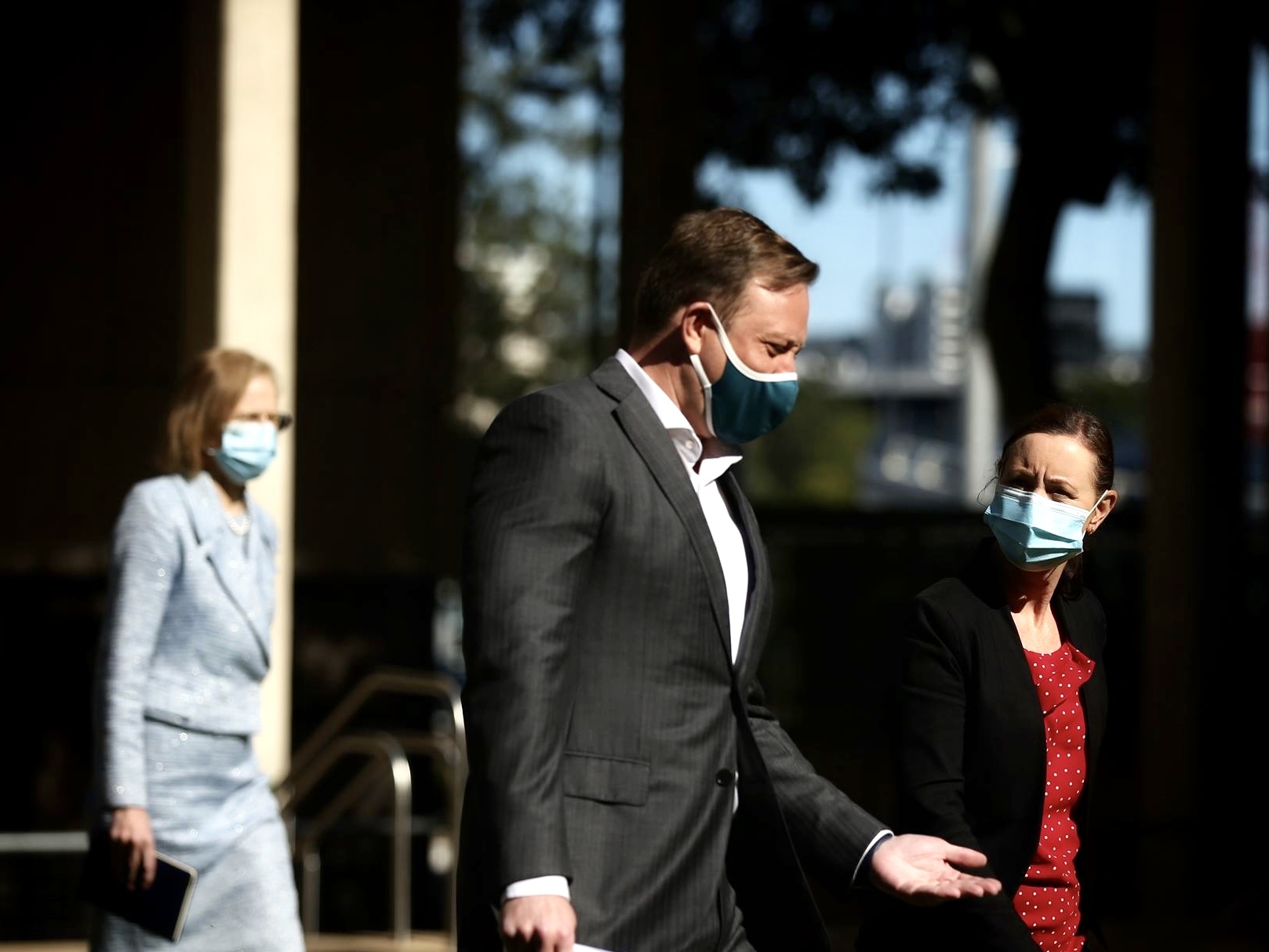 CHO Dr Jeannette Young, Deputy Premier Steven Miles and Health Minister Yvette D'ath walking with masks on
